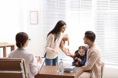 Professional psychologist working with family in office
