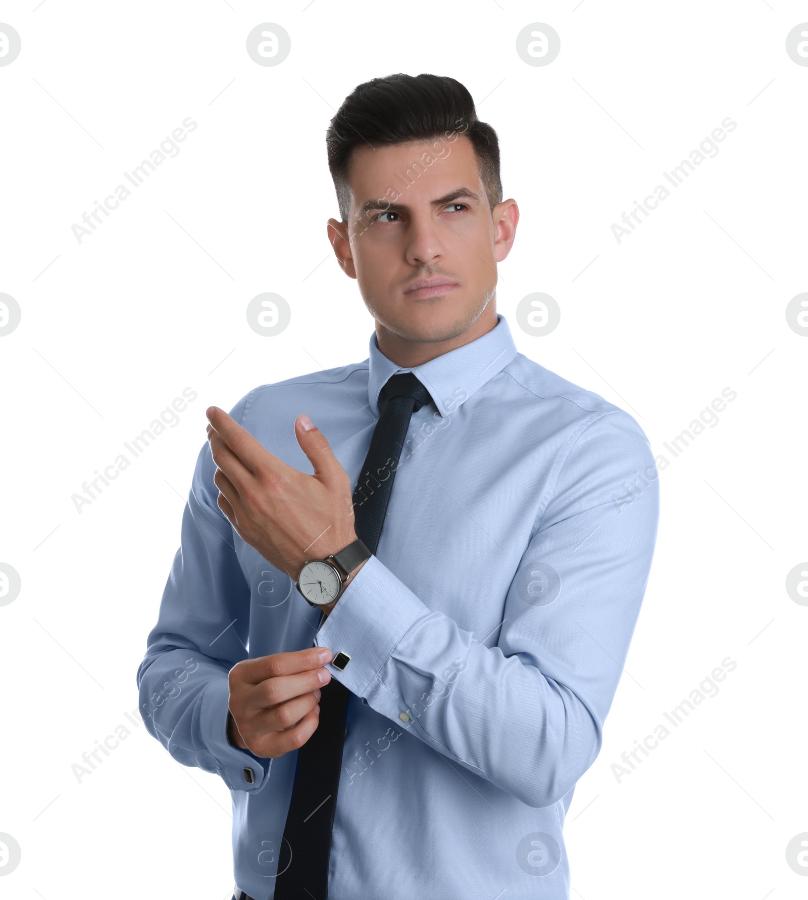 Photo of Handsome stylish man putting on cufflink against white background