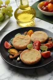 Plate with healthy dish high in vegetable fats on white marble table, closeup