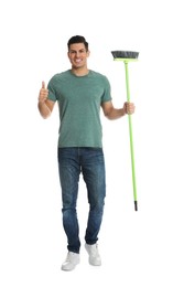 Man with green broom on white background