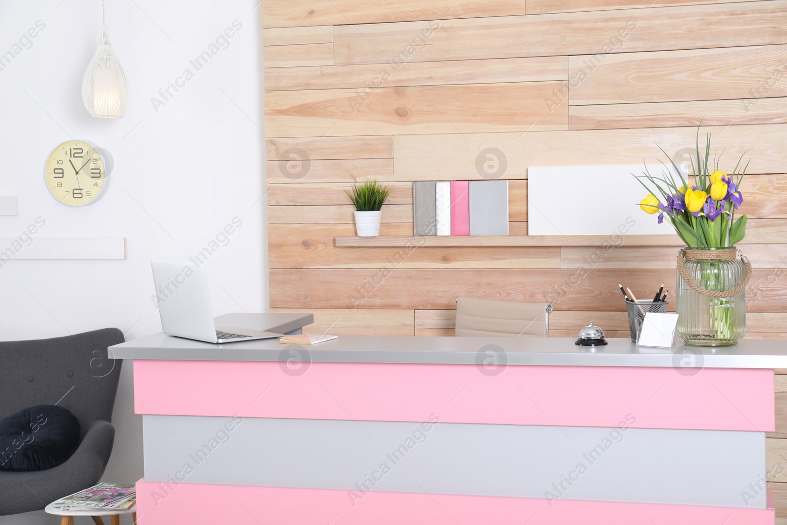 Photo of Stylish interior of beauty salon with modern reception desk near wooden wall