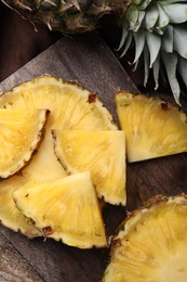 Photo of Pieces of tasty ripe pineapple on table, top view