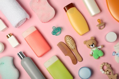 Flat lay composition with baby cosmetic products on pink background