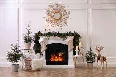 Photo of Stylish room interior with fireplace and beautiful Christmas decor