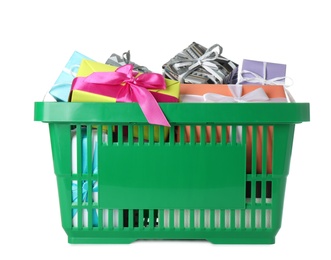 Photo of Green shopping basket with different gifts on white background