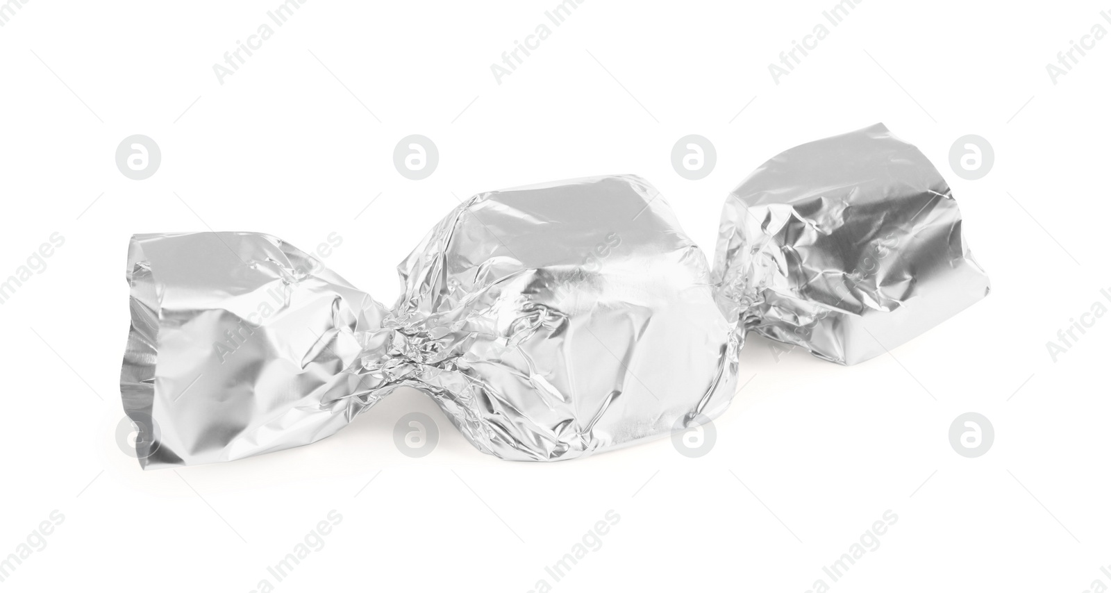 Photo of Tasty candy in silver wrapper isolated on white