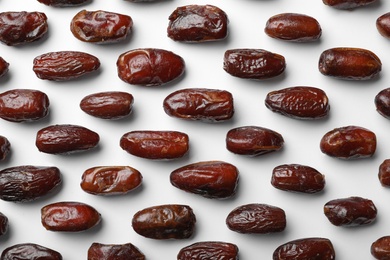Photo of Sweet dried date fruits on white background, top view