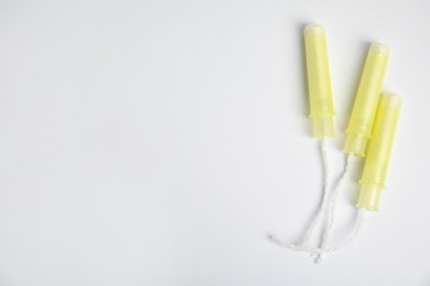 Photo of Tampons on light background, flat lay. Space for text