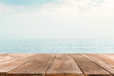 Empty wooden table near sea. Summer season