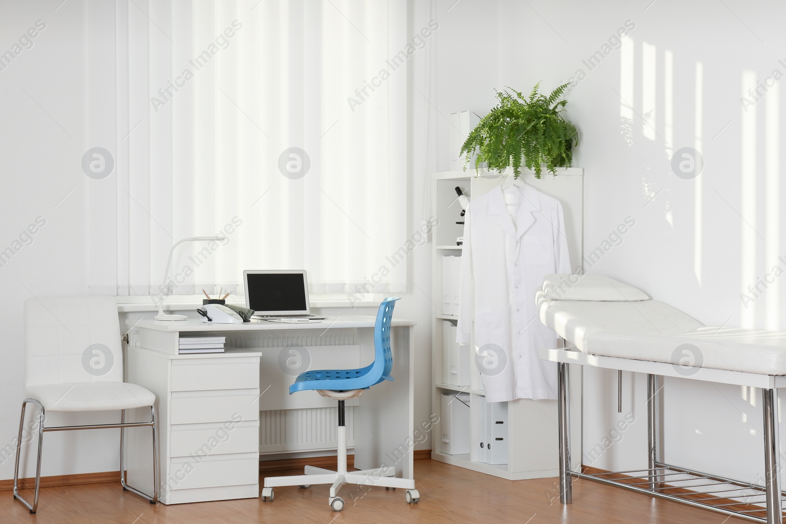 Photo of Interior of modern medical office with doctor's workplace