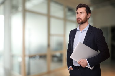 Image of Successful lawyer with laptop on blurred background, space for text