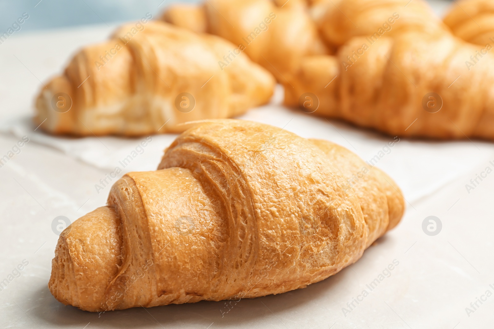 Photo of Tasty croissant on table, closeup