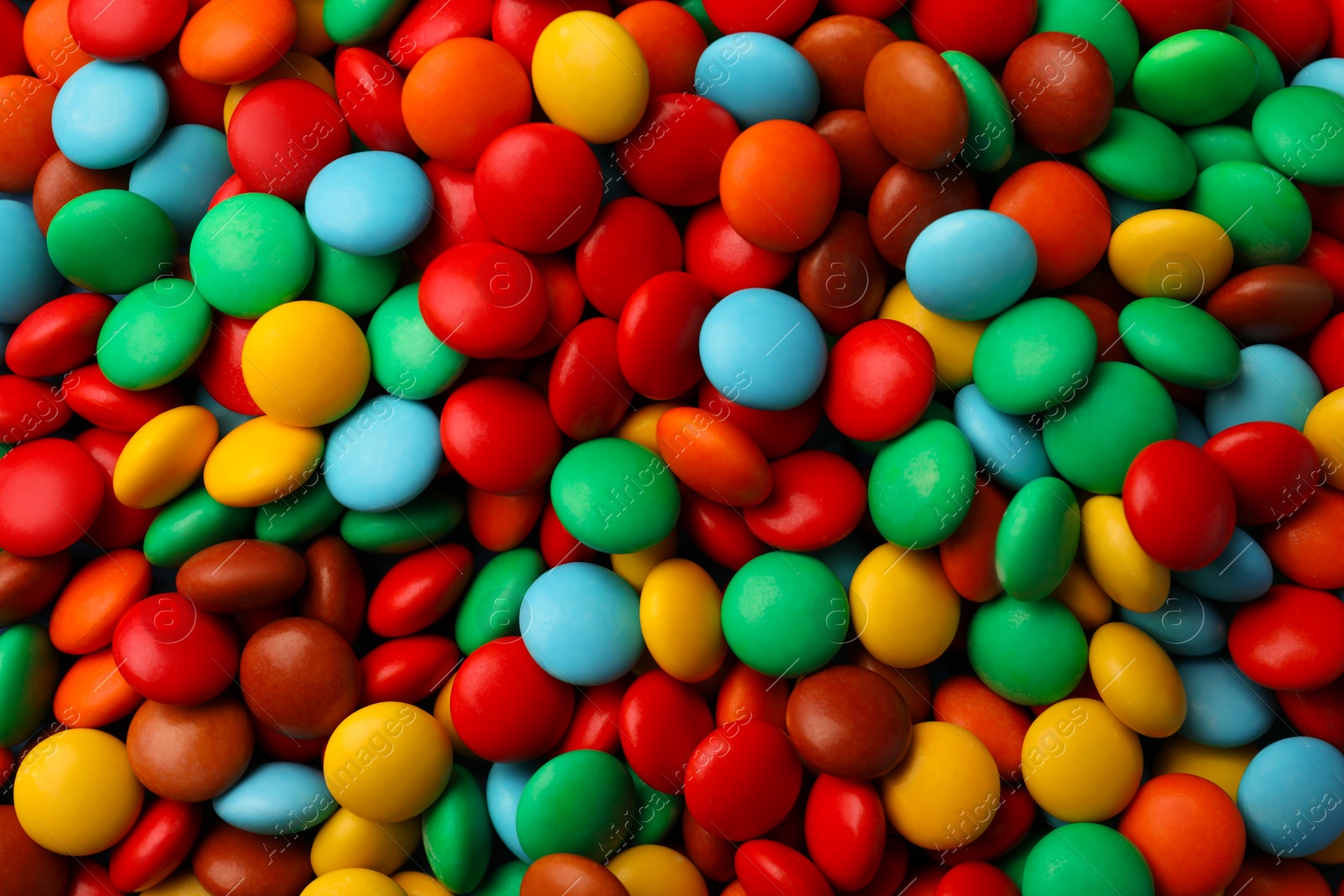 Photo of Tasty colorful candies as background, top view