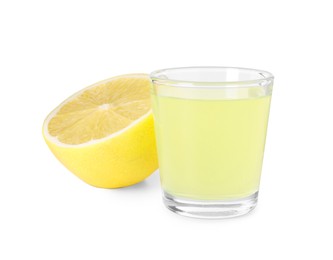Photo of Shot glass with tasty limoncello liqueur and half of lemon isolated on white