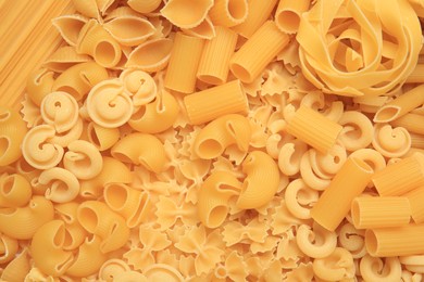 Photo of Different types of pasta as background, top view