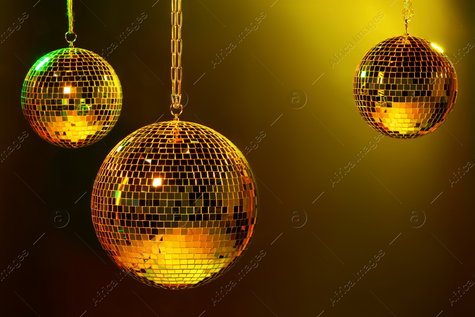 Photo of Shiny bright disco balls under color lights