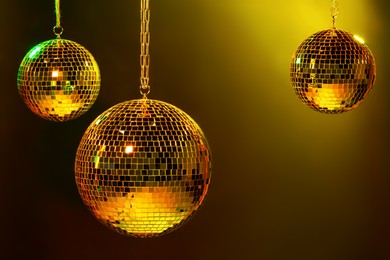 Photo of Shiny bright disco balls under color lights