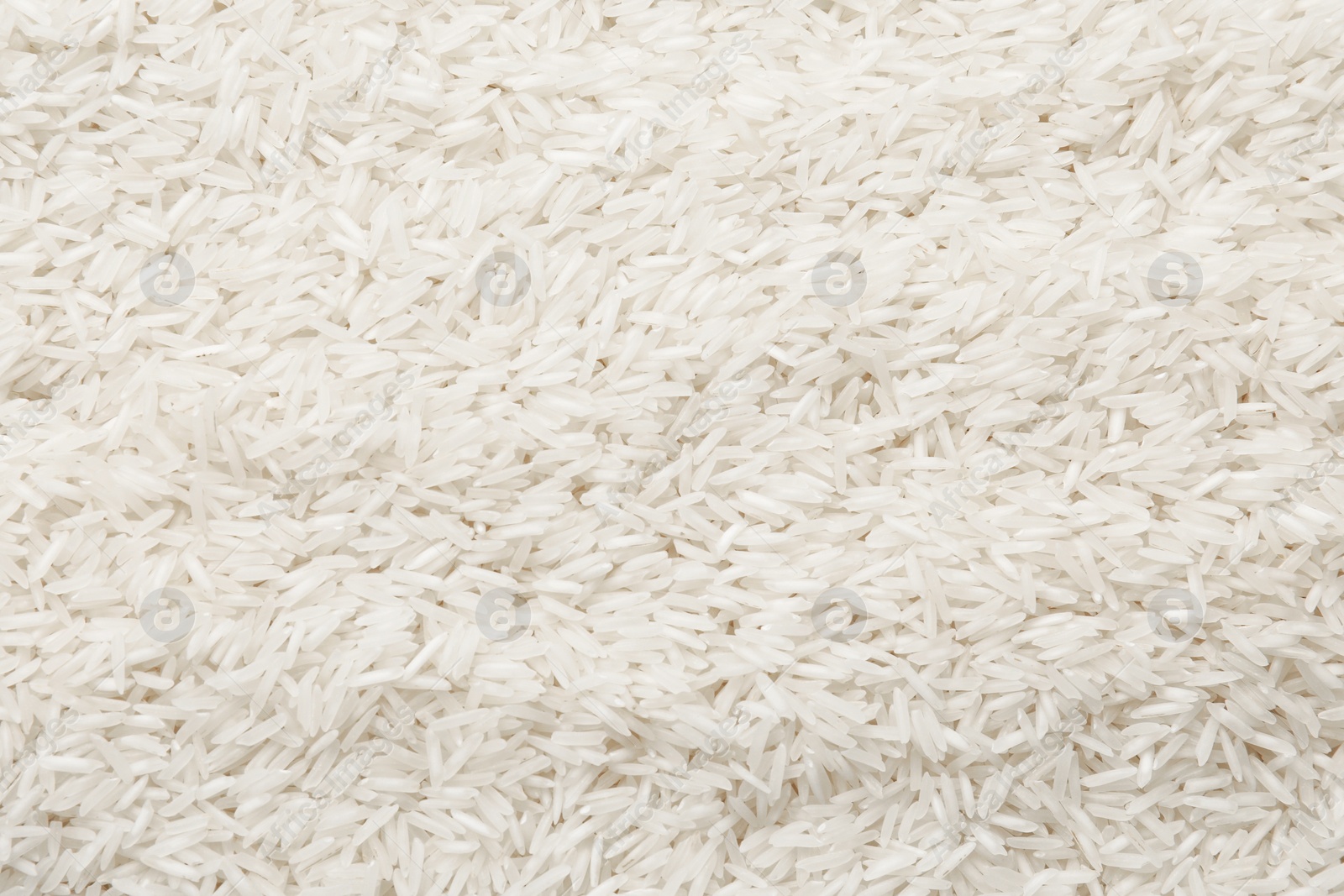 Photo of Raw basmati rice as background, top view