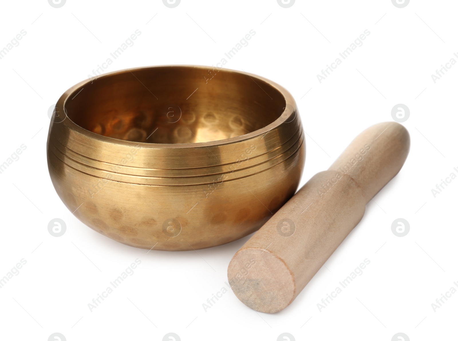 Photo of Golden singing bowl with mallet on white background. Sound healing