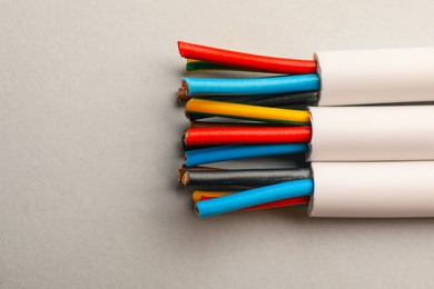 Photo of Electrical cables with wires on light background, closeup
