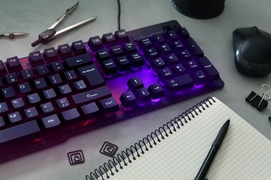 Photo of Modern RGB keyboard and office stationery on grey table