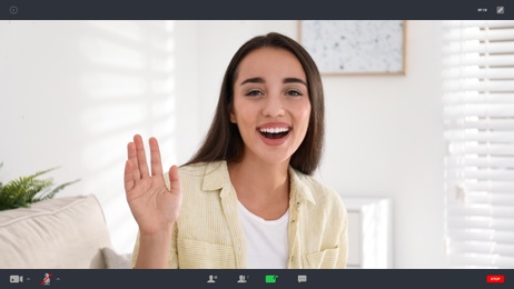 Woman communicating with coworkers from home using video chat, view through camera