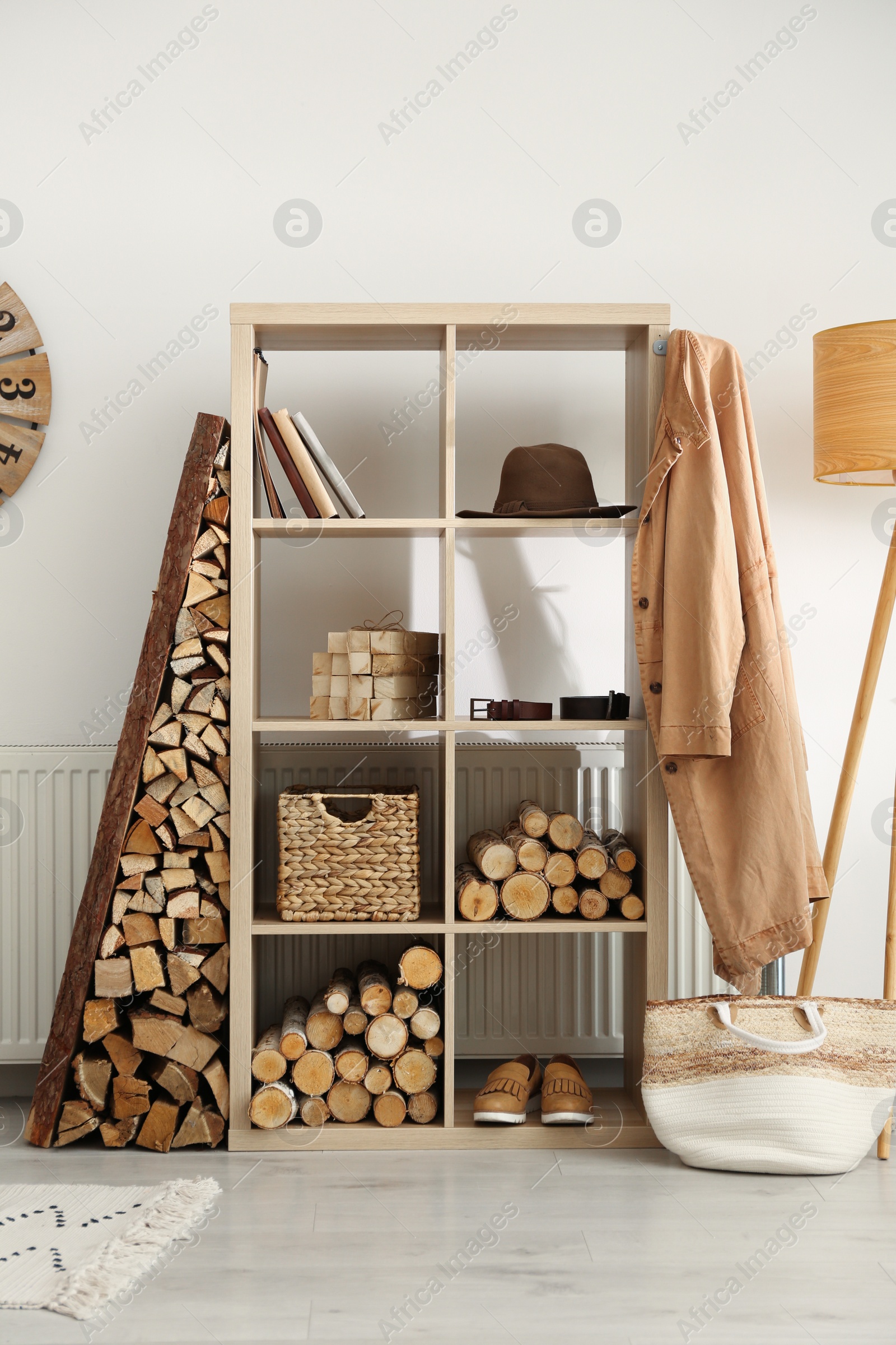 Photo of Stylish room interior with firewood as decorative element