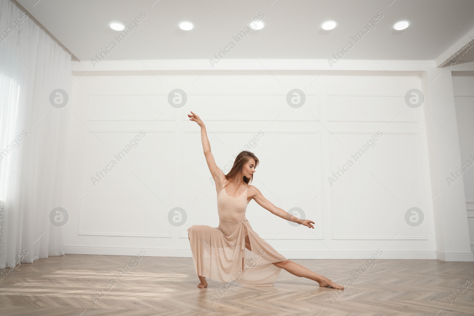 Photo of Beautiful professional dancer practicing moves in studio