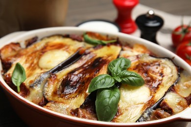 Photo of Delicious eggplant lasagna in baking dish, closeup