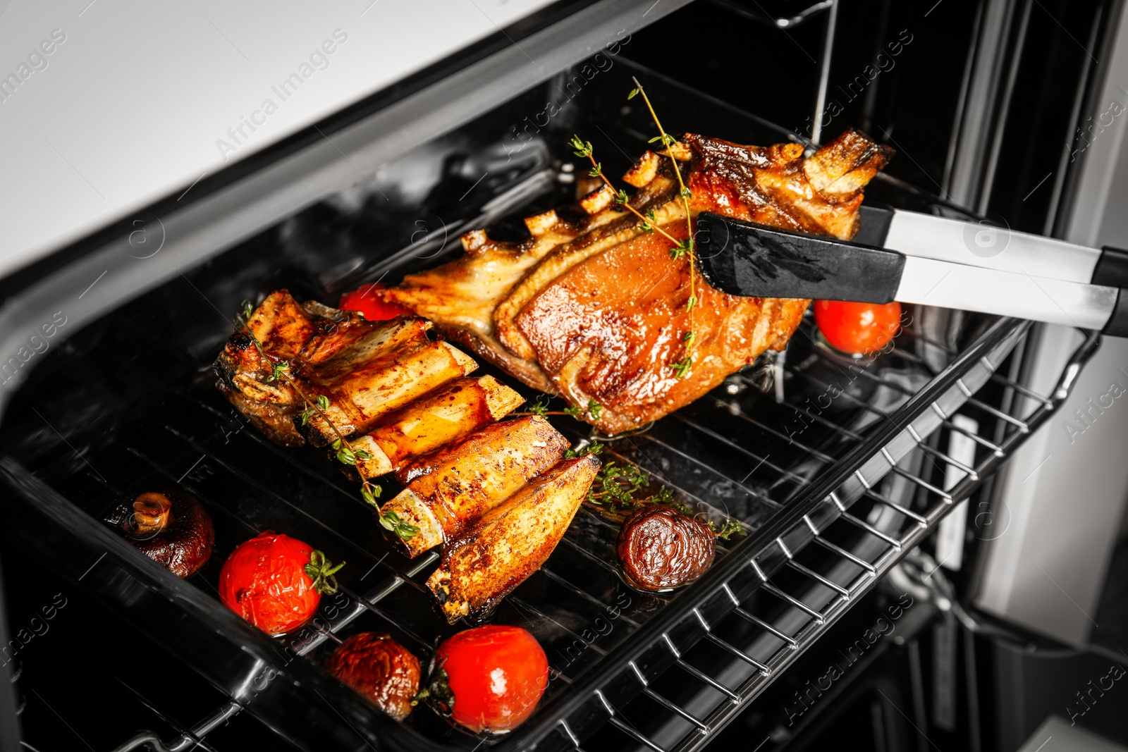 Photo of Delicious roasted ribs in oven, closeup. Yummy meat