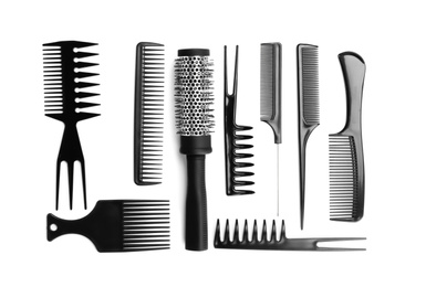 Photo of Set of modern hair combs and brush isolated on white, top view