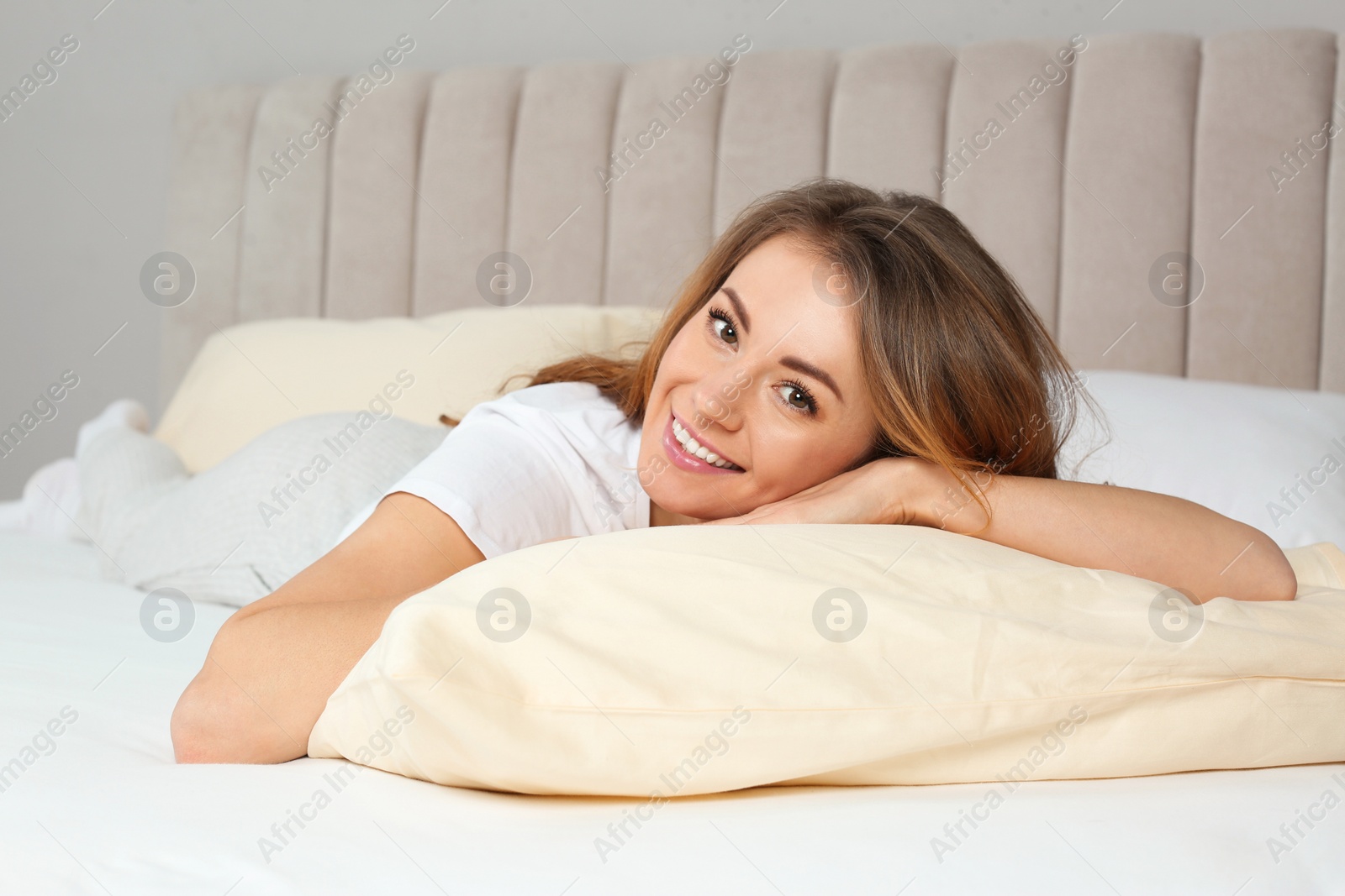 Photo of Portrait of happy beautiful woman in bed at home