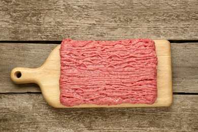 Photo of Board with raw fresh minced meat on wooden table, top view