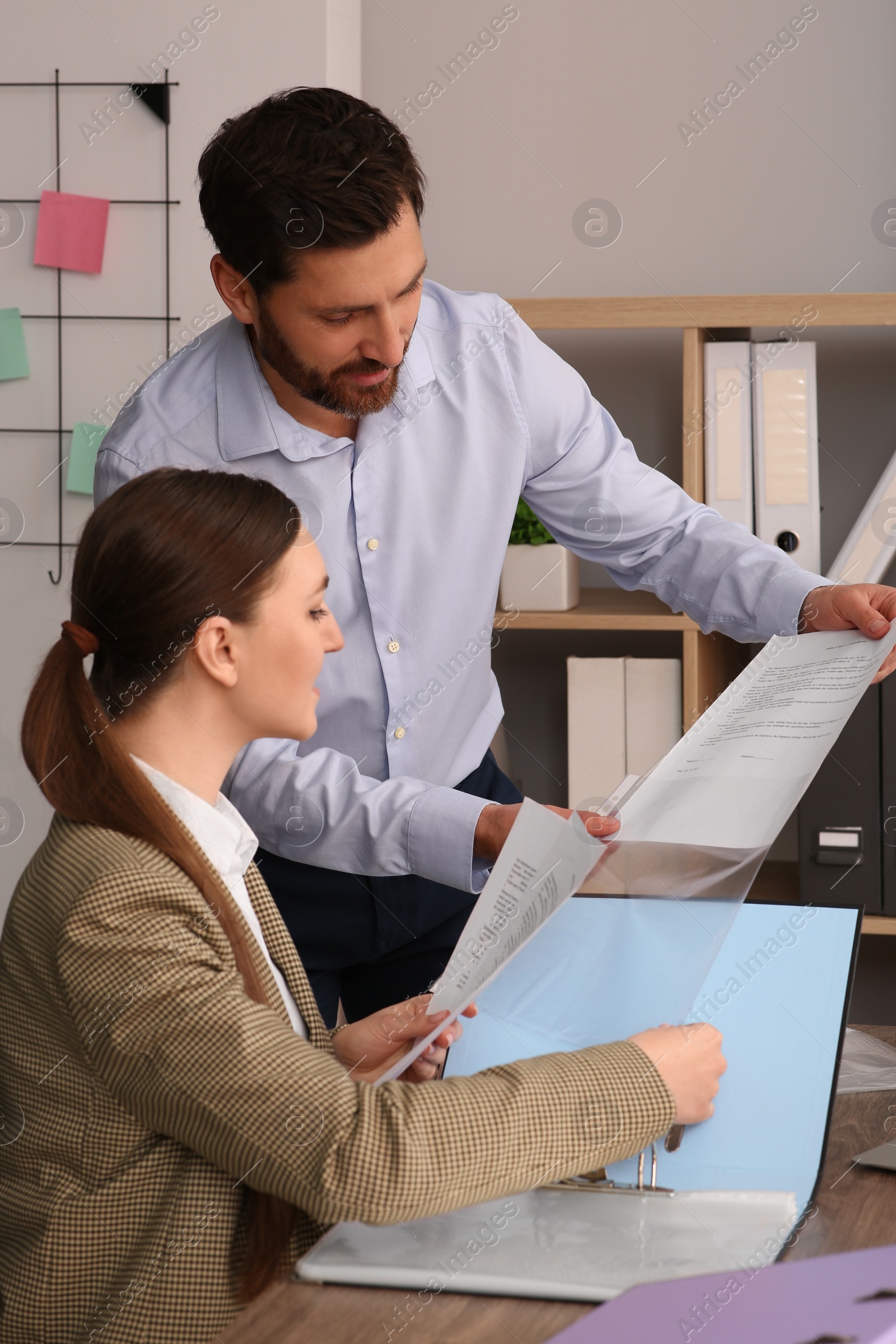 Photo of Businesspeople working together with documents in office