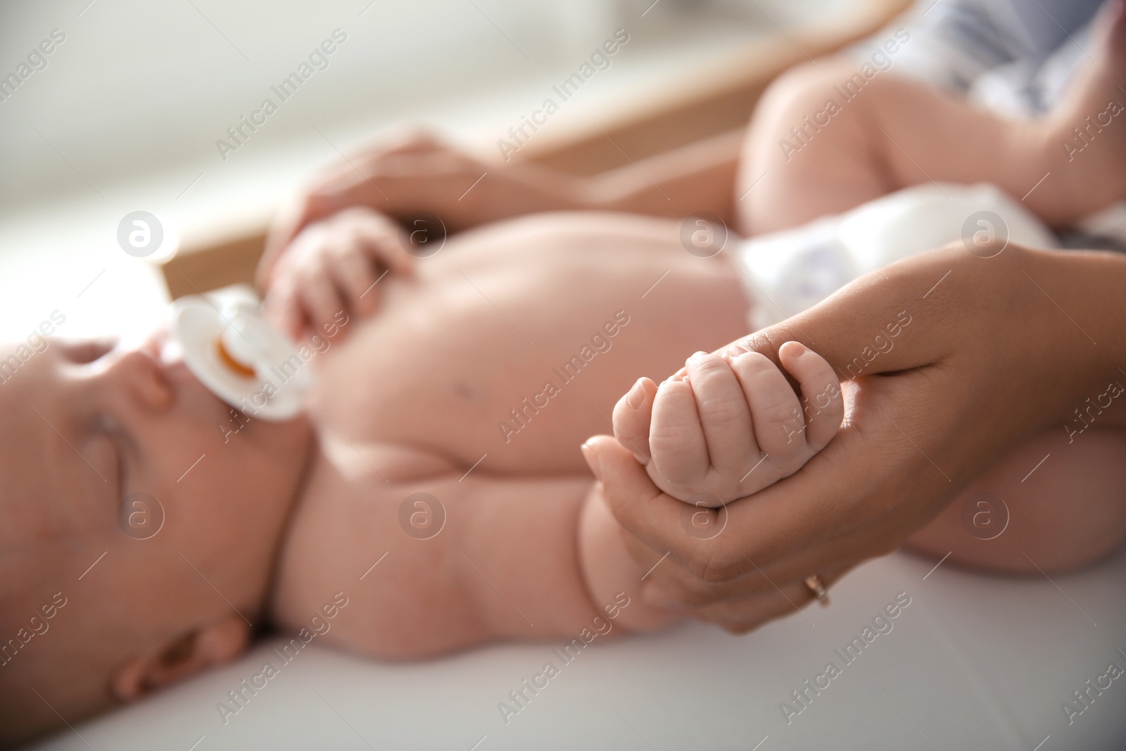 Photo of Mother with her newborn baby, closeup view