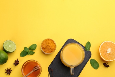 Flat lay composition with immunity boosting drink on yellow background. Space for text