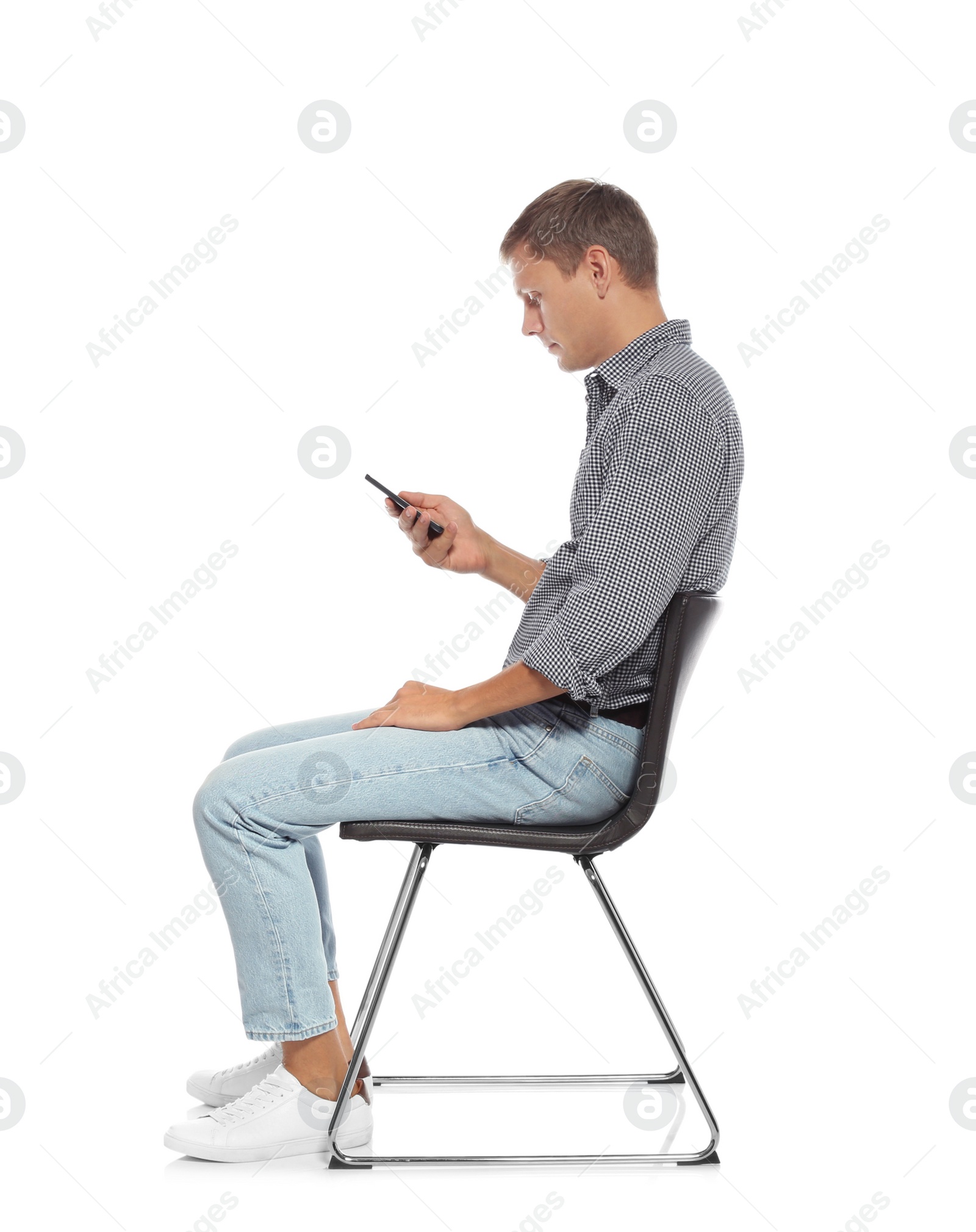 Photo of Man with poor posture using smartphone while sitting on chair against white background