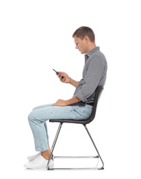 Photo of Man with poor posture using smartphone while sitting on chair against white background