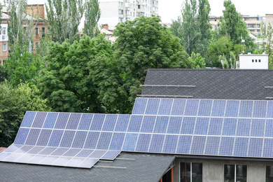 Building with installed solar panels on roof. Alternative energy source