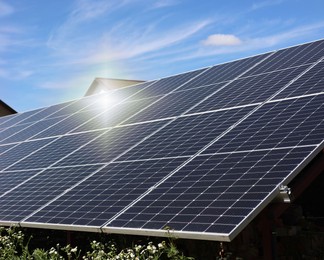 Photo of Solar panels under blue sky on sunny day. Alternative energy source