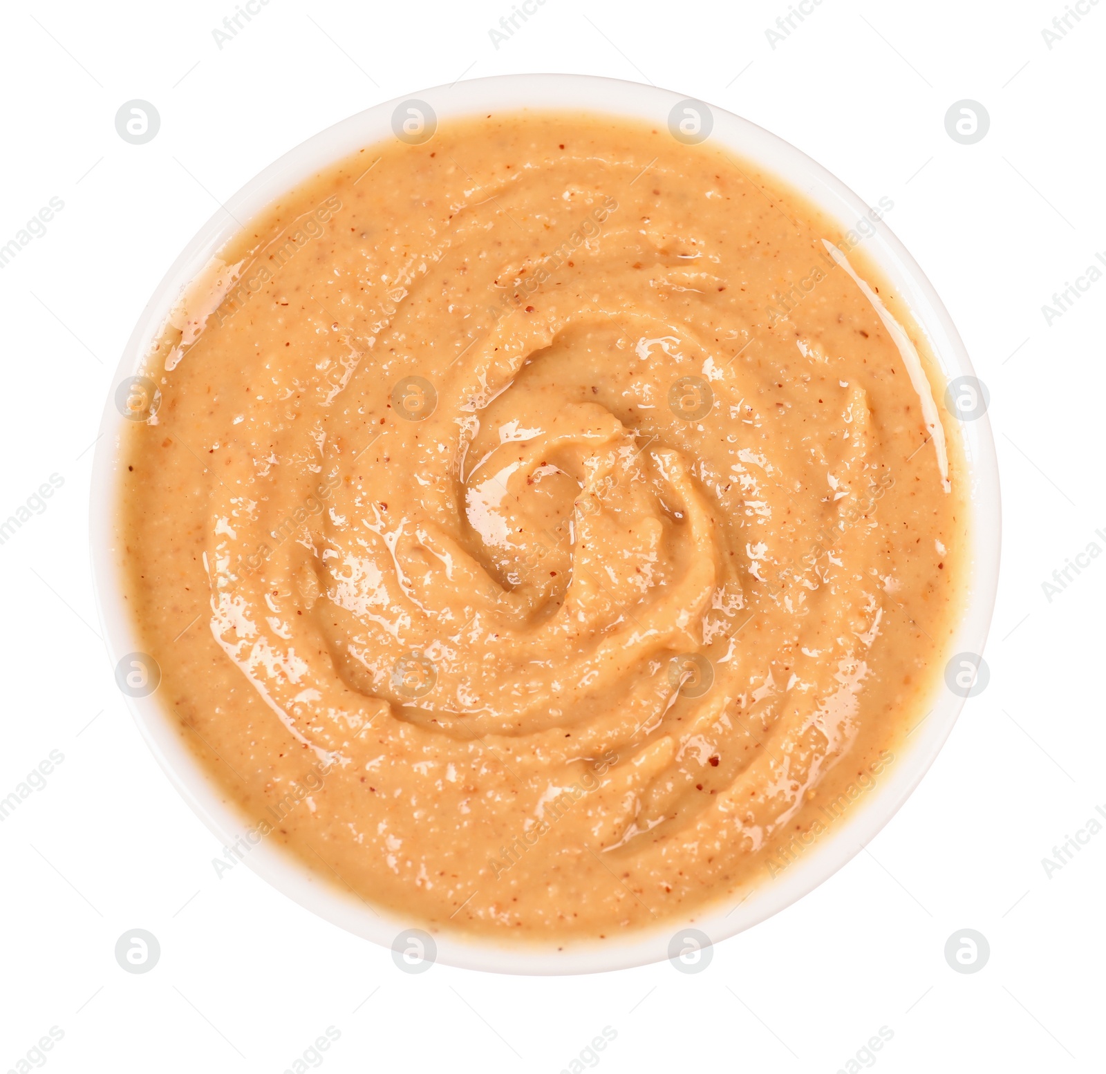 Photo of Delicious nut butter in bowl isolated on white, top view