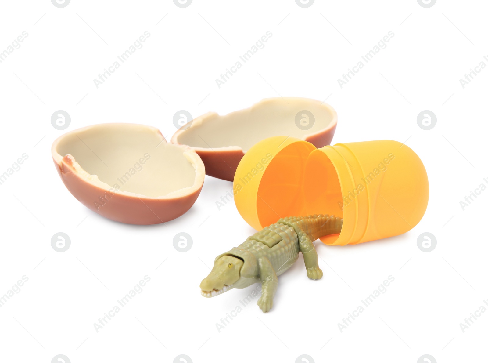 Photo of Slynchev Bryag, Bulgaria - May 24, 2023: Halves of Kinder Surprise Egg, plastic capsule and toy crocodile isolated on white