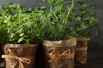 Different aromatic potted herbs on table, closeup