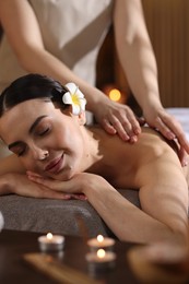 Photo of Spa therapy. Beautiful young woman lying on table during massage in salon