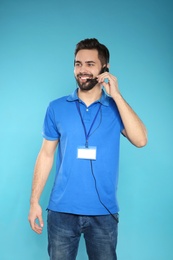 Photo of Portrait of technical support operator with headset on color background