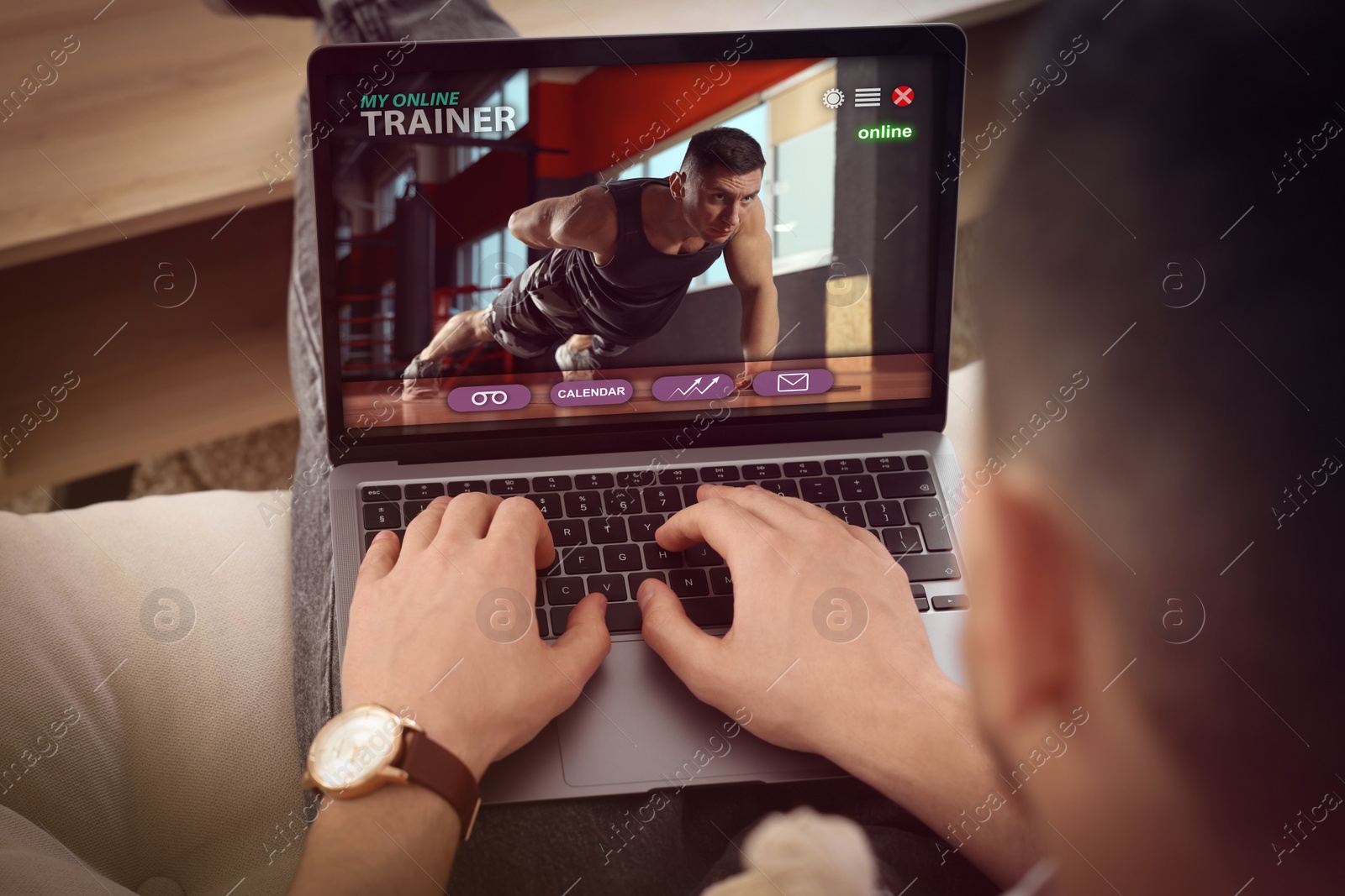 Image of Personal trainer online. Man viewing website via laptop at home, closeup