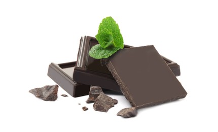 Tasty dark chocolate pieces with mint on white background