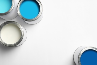 Open paint cans on white background, top view. Space for text