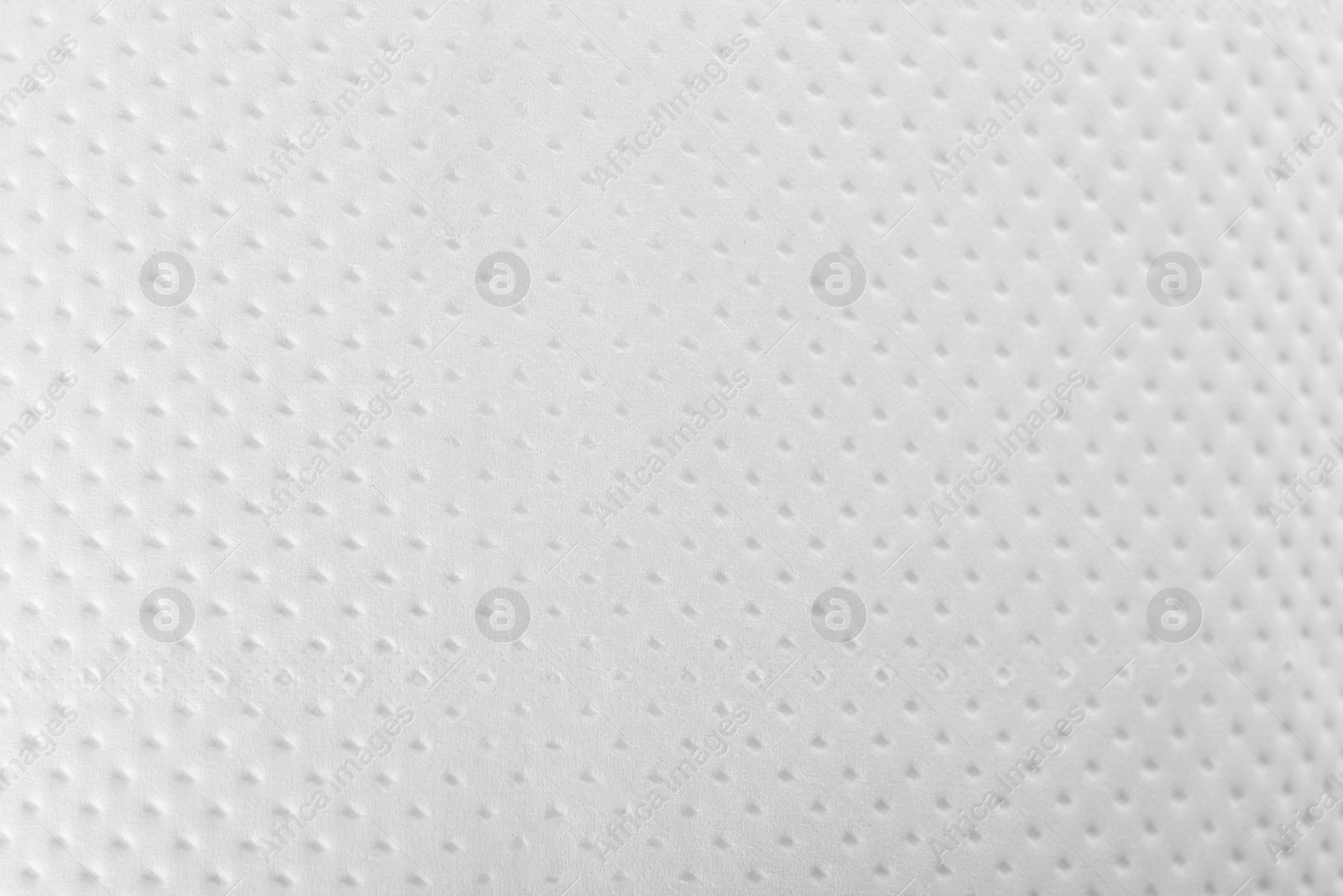 Photo of Perforated toilet paper as background, closeup. Personal hygiene