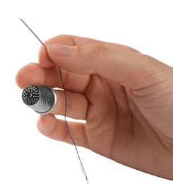 Photo of Woman with thimble, thread and sewing needle on white background, closeup